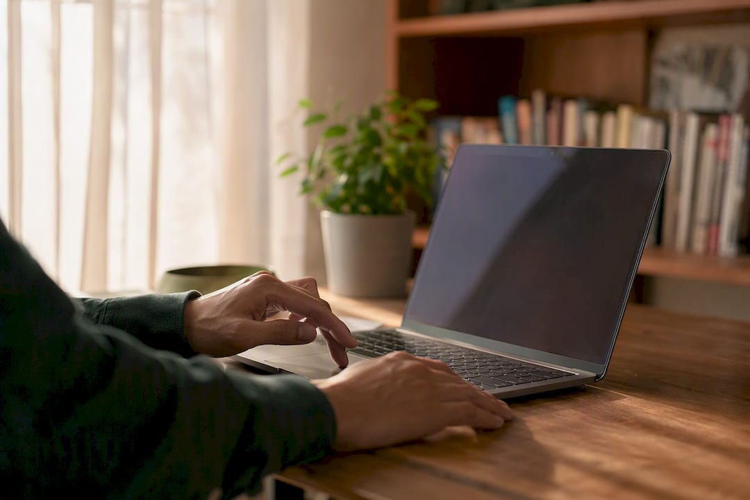 Hands near dark laptop with traffic data