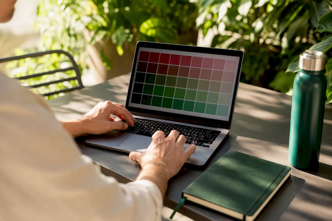 Hands using colour palette and simulator for accessibility testing
