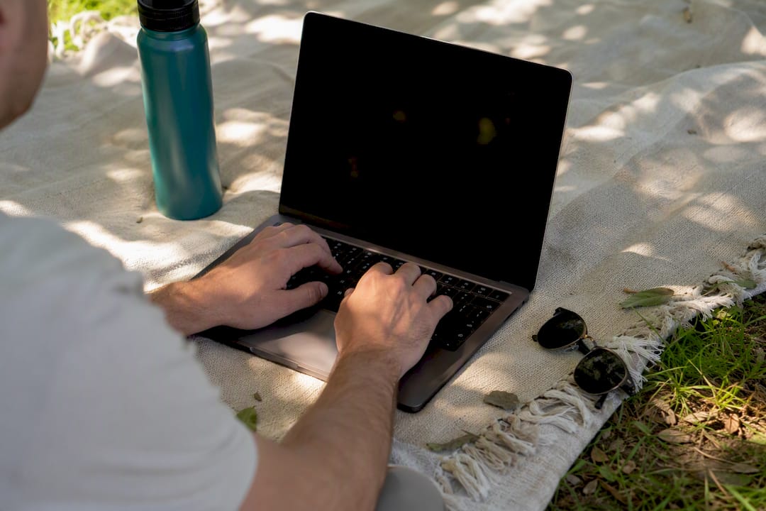 Hands typing JSON-LD code on laptop keyboard