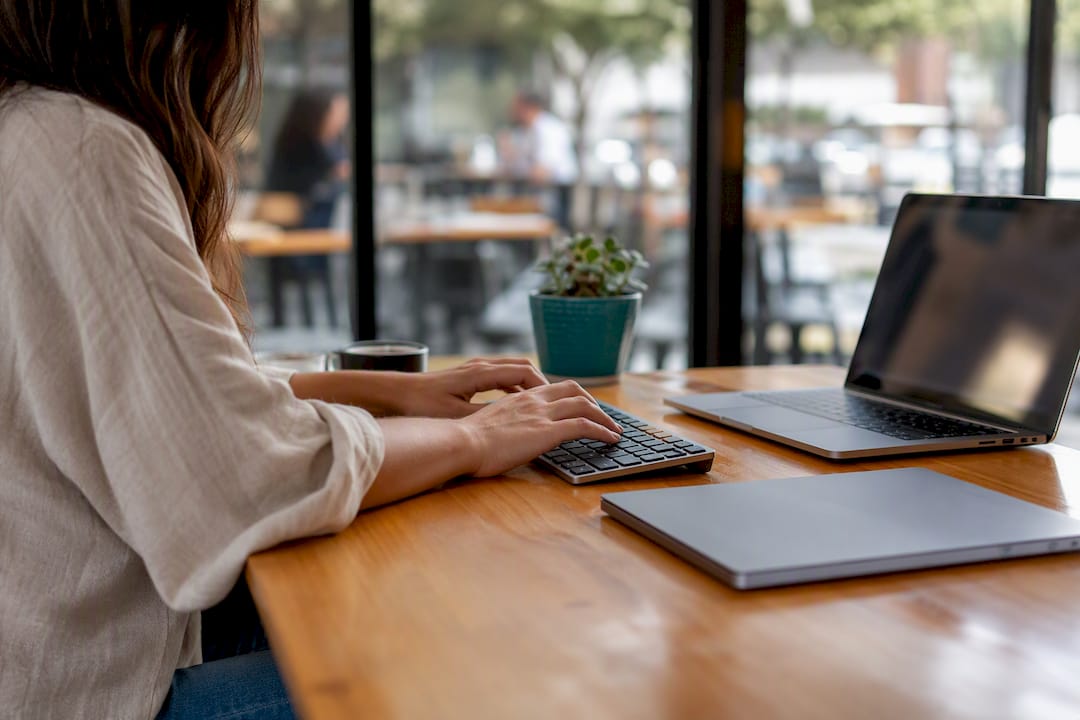 Hands typing on keyboard at minimalist desk